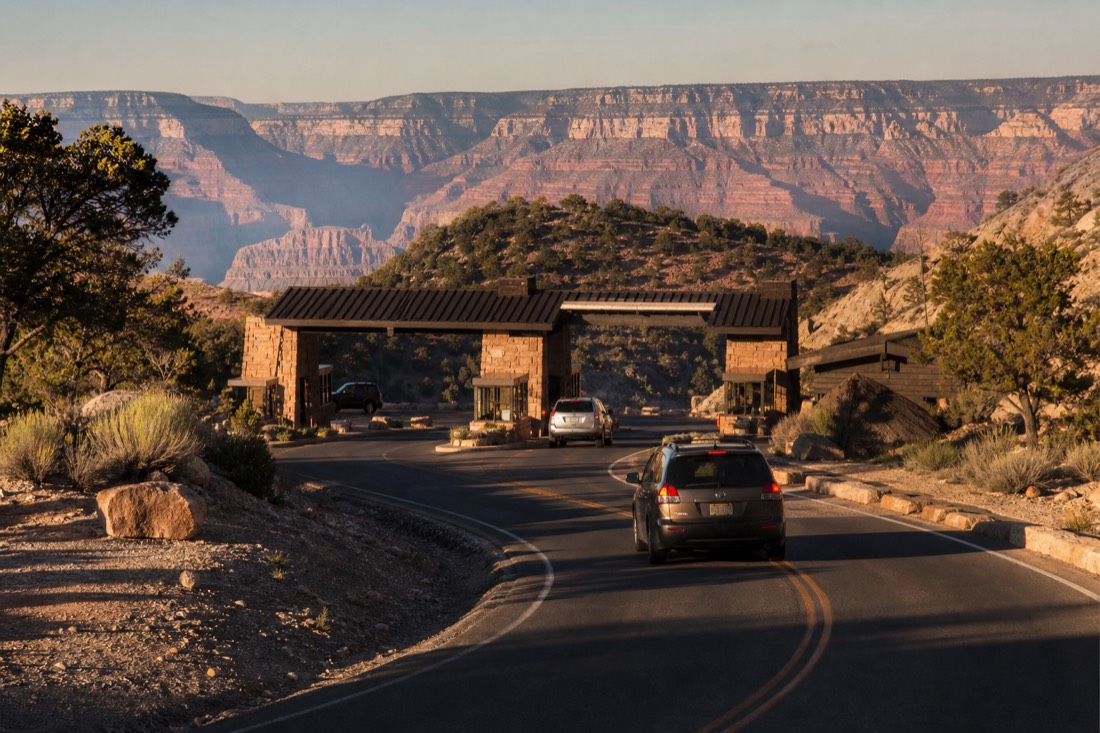 Cars passing freely through the South Rim entrance station of Grand Canyon National Park on a clear morning