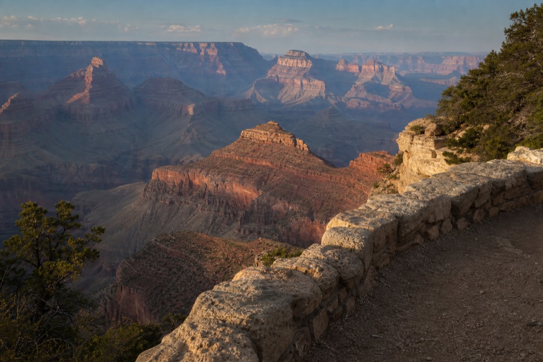 Late afternoon light on the South Rim of the Grand Canyon with layered buttes receding into haze