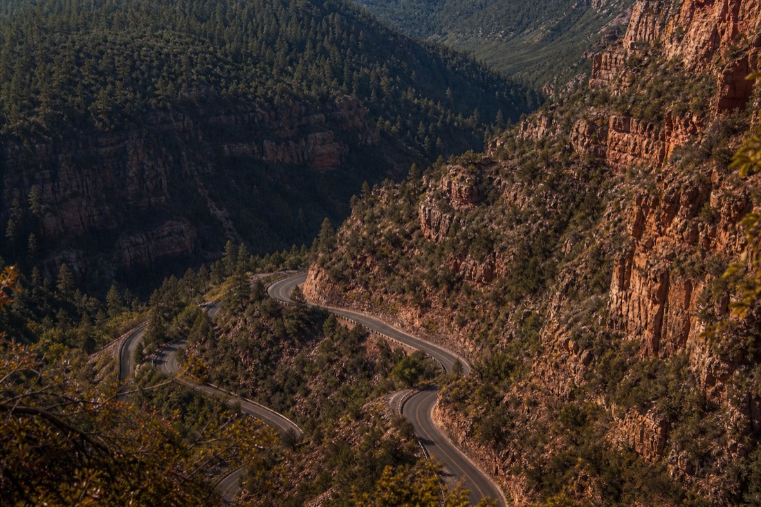 The 89A switchbacks climbing through Oak Creek Canyon with pine forest and red rock walls on both sides